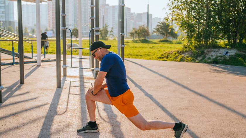 athletic man stretching his legs in preparation