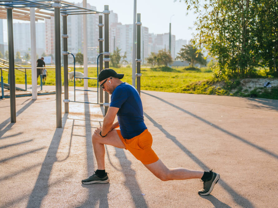 athletic man stretching his legs in preparation