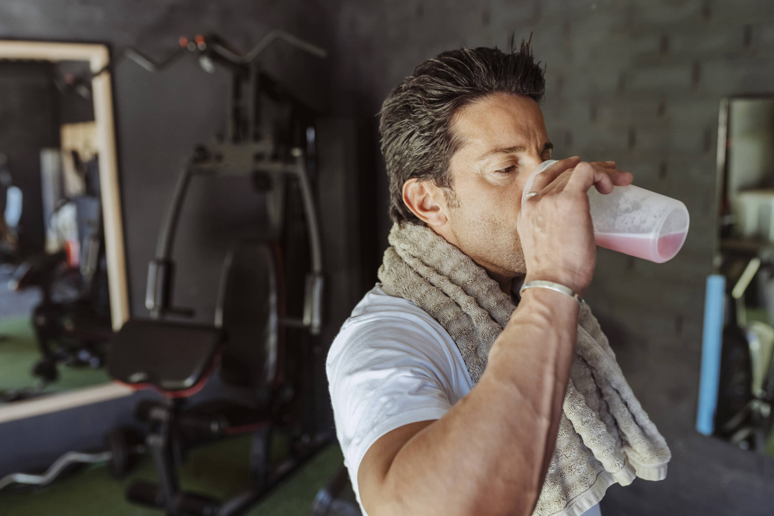 muscular man drinking protein shake scaled